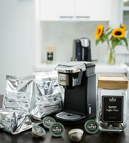 Tayst Compact Single-Serve Coffee Machine Gift Box with brewer and Tayst coffee products.