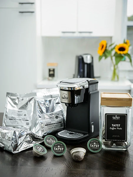 Tayst Compact Single-Serve Coffee Machine Gift Box with brewer and Tayst coffee products.