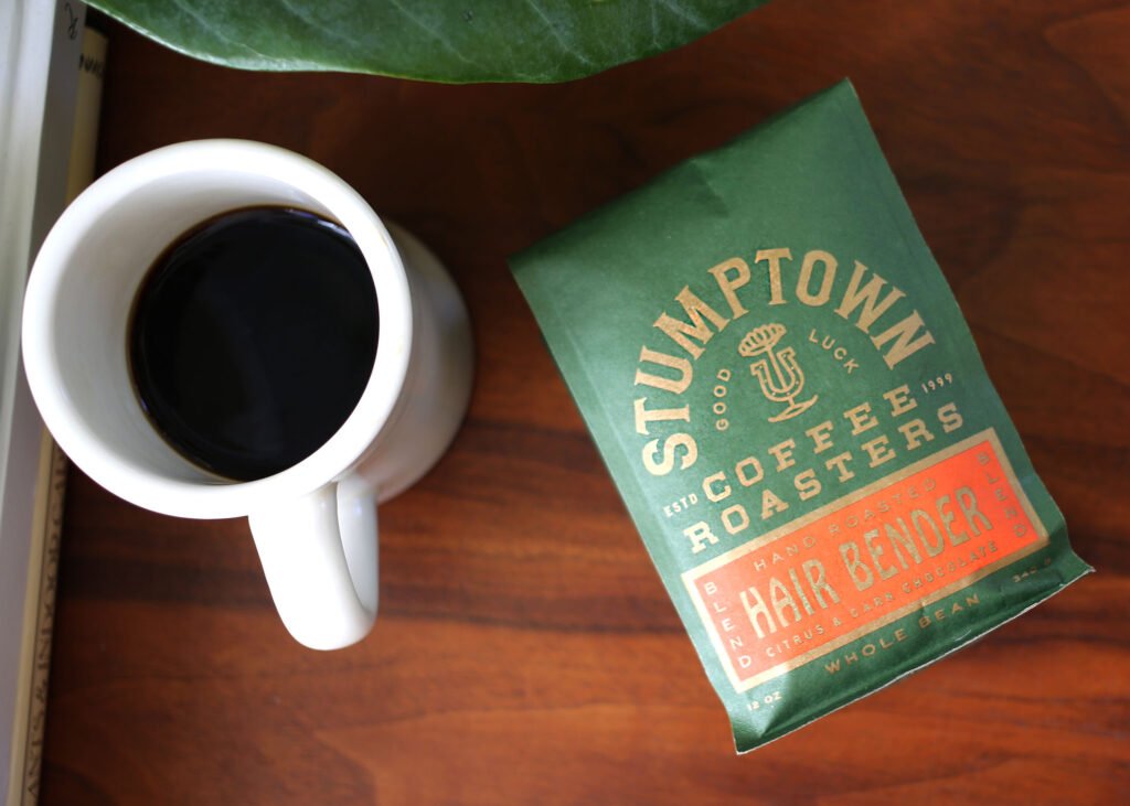 Stumptown Hair Bender coffee bag with a cup of coffee.